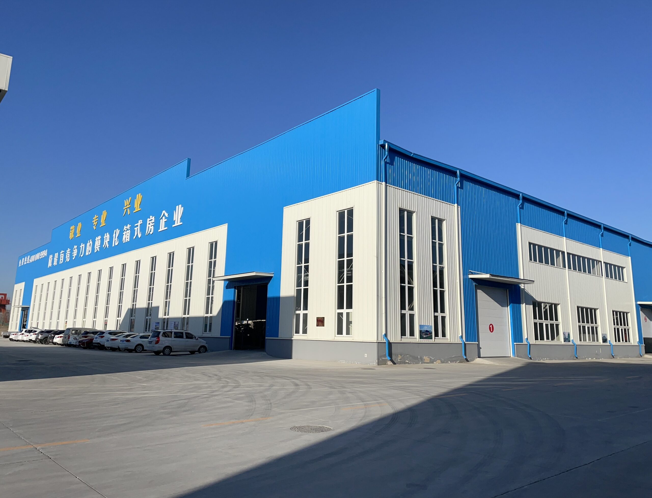 MZ ECO modular house factory building with blue and white corrugated steel facade