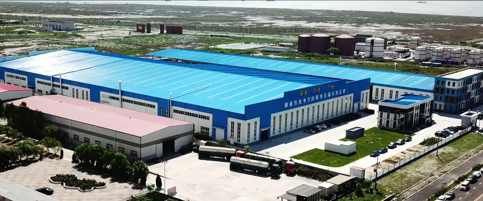 Aerial view of the MZ ECO HOUSE production base with blue-roofed factory buildings