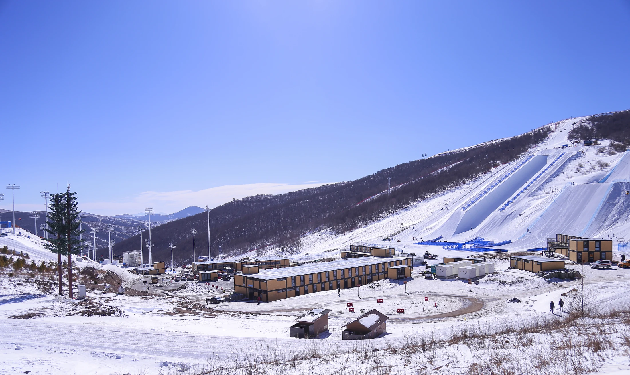 Modular buildings beside a snow-covered ski slope