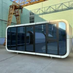 Angled view of the A30 apple cabin showing its curved white enclosure and glass front