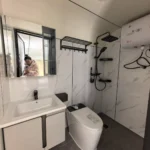 A30 apple cabin bathroom with a vanity, toilet and shower
