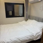 Bedroom in the A70 apple cabin with a double bed and side window