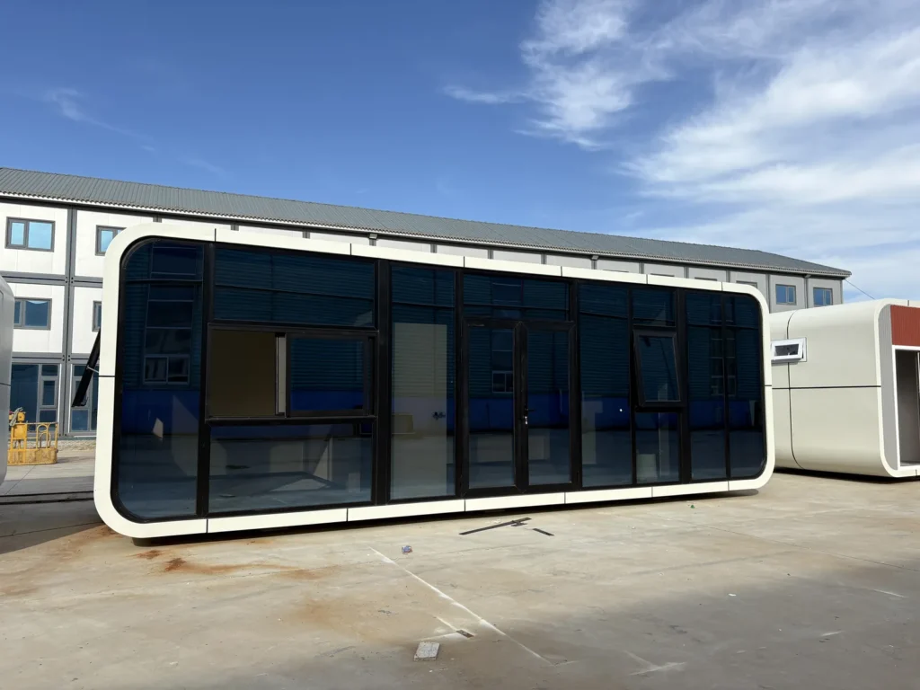 Office apple cabin with a wide black-framed glass front and white rounded trim