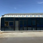 Front elevation of the glass-front office apple cabin in the factory yard