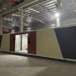 Long public restroom apple cabin with yellow, red and dark grey exterior panels