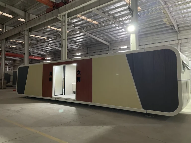 Long public restroom apple cabin with yellow, red and dark grey exterior panels