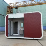 Compact red restroom apple cabin with a recessed entrance and white rounded trim