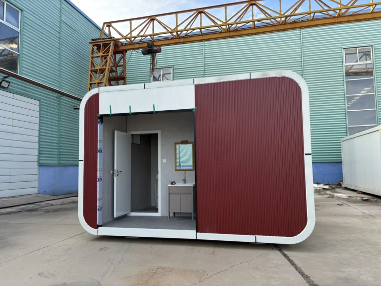 Compact red restroom apple cabin with a recessed entrance and white rounded trim