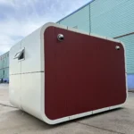 Rear and side view of the red restroom apple cabin showing ventilation outlets