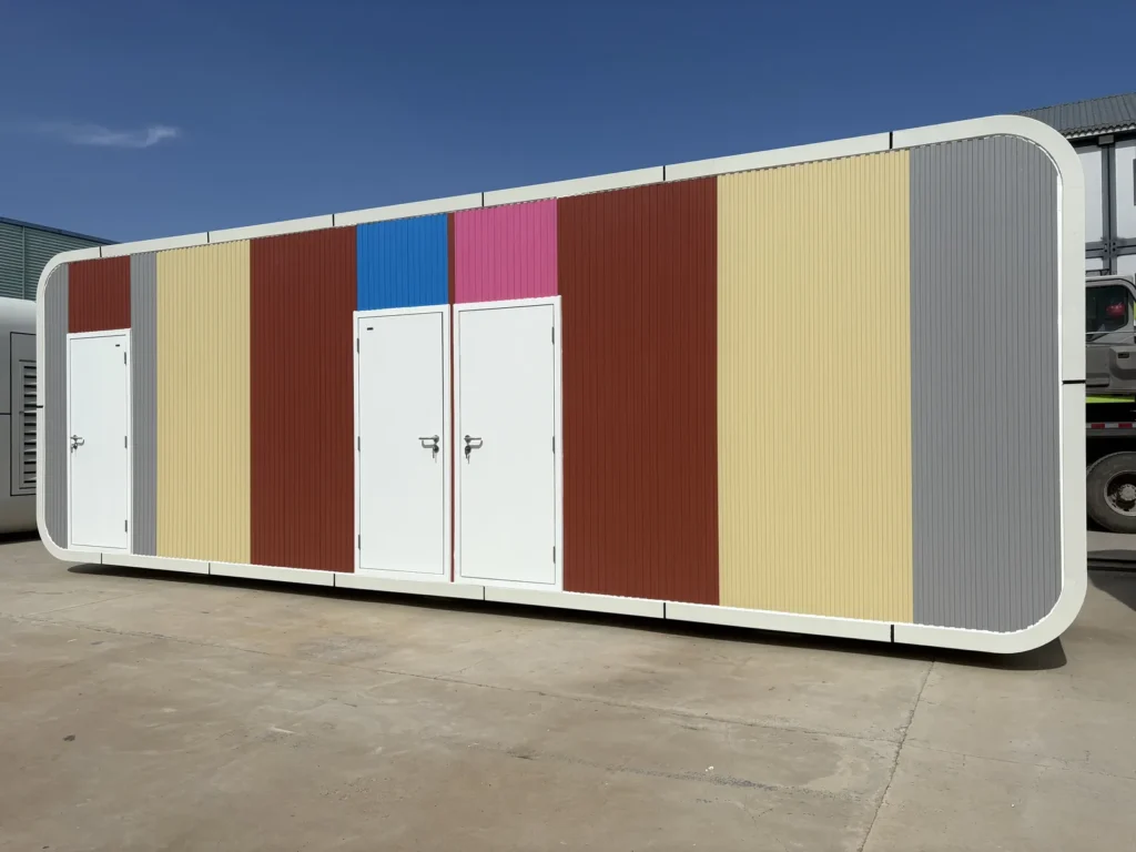 Apple cabin shower facilities with several entrance doors and coloured exterior panels