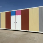 Apple cabin shower facilities with several entrance doors and coloured exterior panels
