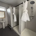 Shower tray and fittings inside a compartment of the apple cabin