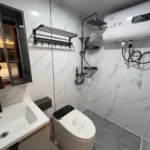 Bathroom in the yellow apple cabin with a shower, vanity and toilet
