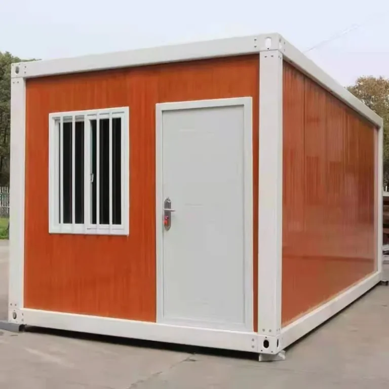 Orange-panel detachable container house with white framing and an end-wall door beside a barred window