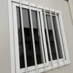 Close-up of the white-framed window and exterior bars on the detachable container house