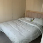 Furnished bedroom with a bed inside the wood-look detachable cabin