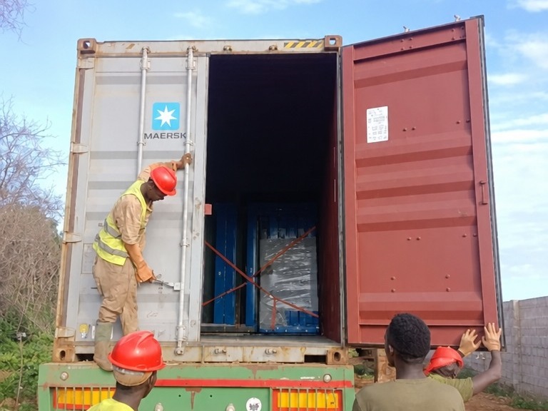 MZ ECO container house shipment loaded inside an open shipping container on a truck for delivery