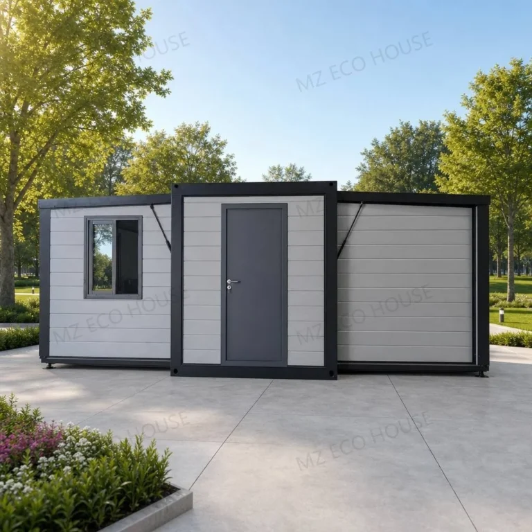 Front reference of a grey expandable container house with black framing and a solid entrance door