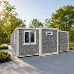 Rear reference of a stone-look expandable container house with white framing and a small high-level window