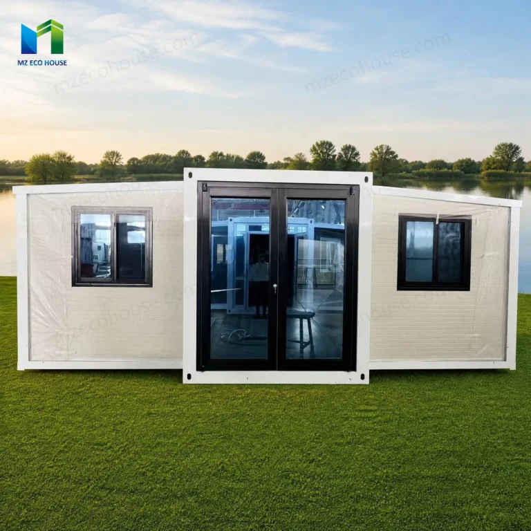 Front reference of a white expandable container house with a dark glazed entrance and windows on both wings