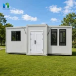 Front reference of a white expandable container house with a solid entrance door between two window groups