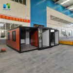 Wood-look expandable container house during assembly with the front wing panels open
