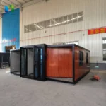 Opposite side of a wood-look expandable container house during factory assembly