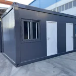 Grey flat pack container cabin with two entrance doors and barred windows