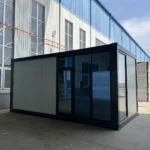 Flat pack container office with dark framing and a partly glazed facade