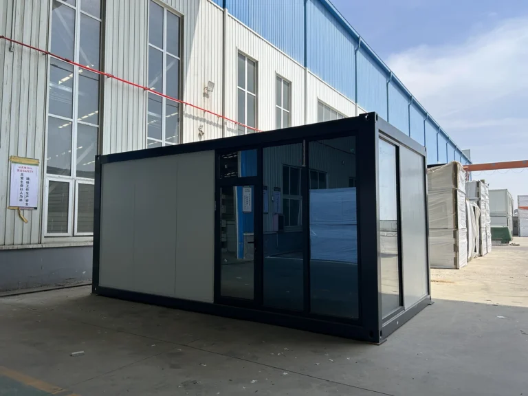 Flat pack container office with dark framing and a partly glazed facade