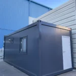 Grey flat pack staff rest cabin exterior