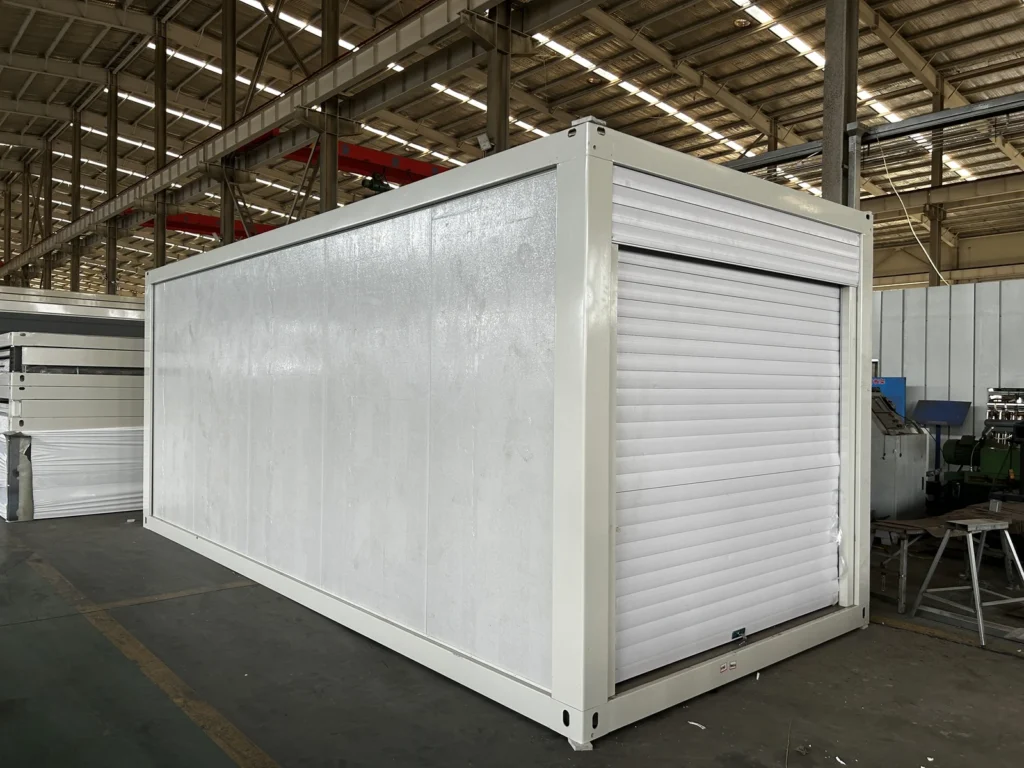 Flat pack storage container with a roller shutter door