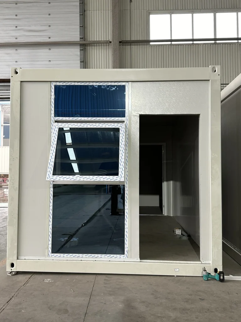 Flat pack container suite with tall glazing beside the entrance