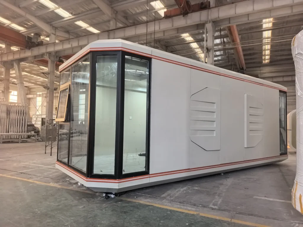 Long assembled space capsule reference with light panels, warm edge trim and a dark glazed end
