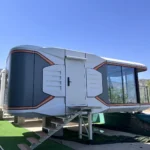 E50 space capsule house with warm-coloured trim, a covered balcony and entrance steps