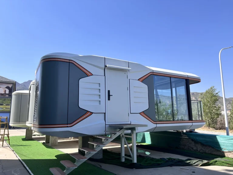 E50 space capsule house with warm-coloured trim, a covered balcony and entrance steps