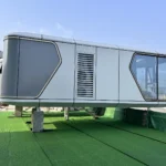 G50S space capsule house with grey geometric side panels and panoramic glazing on a display platform
