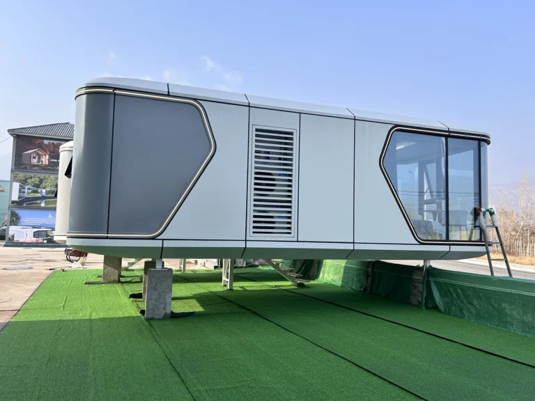 G50S space capsule house with grey geometric side panels and panoramic glazing on a display platform