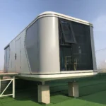 Rounded glazed end of the G50S space capsule house with an open awning window