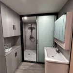 G50S bathroom with a vanity, storage cabinets and a glass shower enclosure