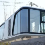 Opposite end and side elevation of the white G70 space capsule house