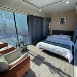 Furnished G70 bedroom with panoramic glazing and a seating area
