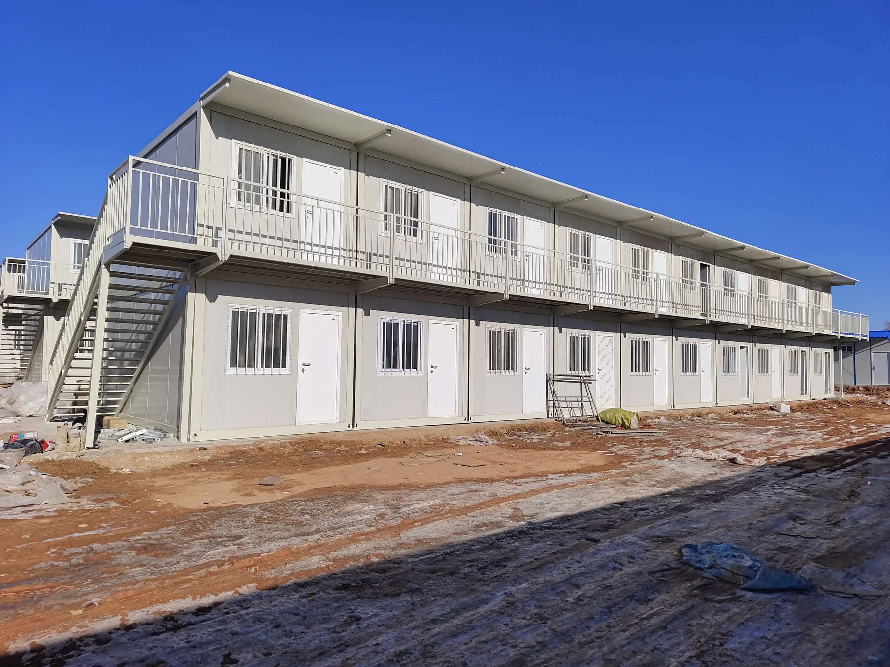 Two-storey white modular buildings at a project site